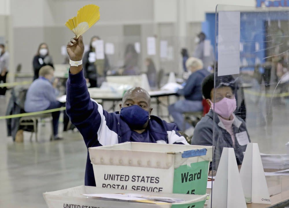 A election worker requests help while recounting ballots at the presidential election recount at the Wisconsin Center Saturday, Nov. 21, 2020, in Milwaukee. (Mike De Sisti/Milwaukee Journal-Sentinel via AP)