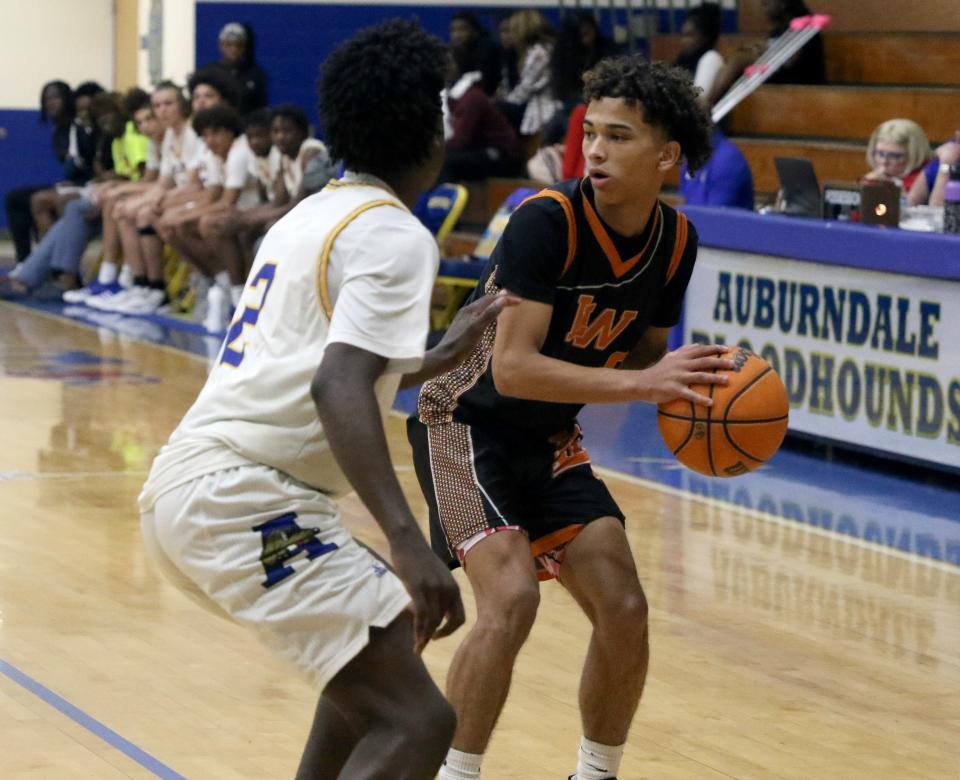 Lake Wales Sevastian Rosado looks to pass as he is being guarded by Auburndale's Kervan Knaggs on Wednesday in the semifinals of the Class 5A, District 7 boys basketball tournament at the Tracy McGrady Gymnasium.