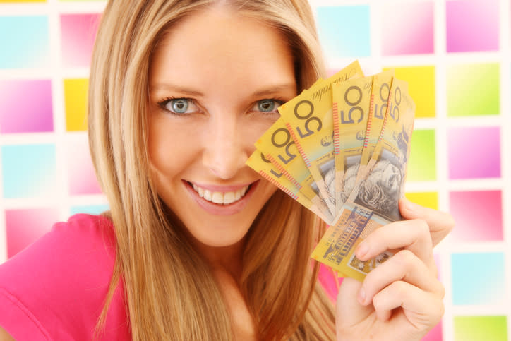 Woman in pink on colorful square background with australian money