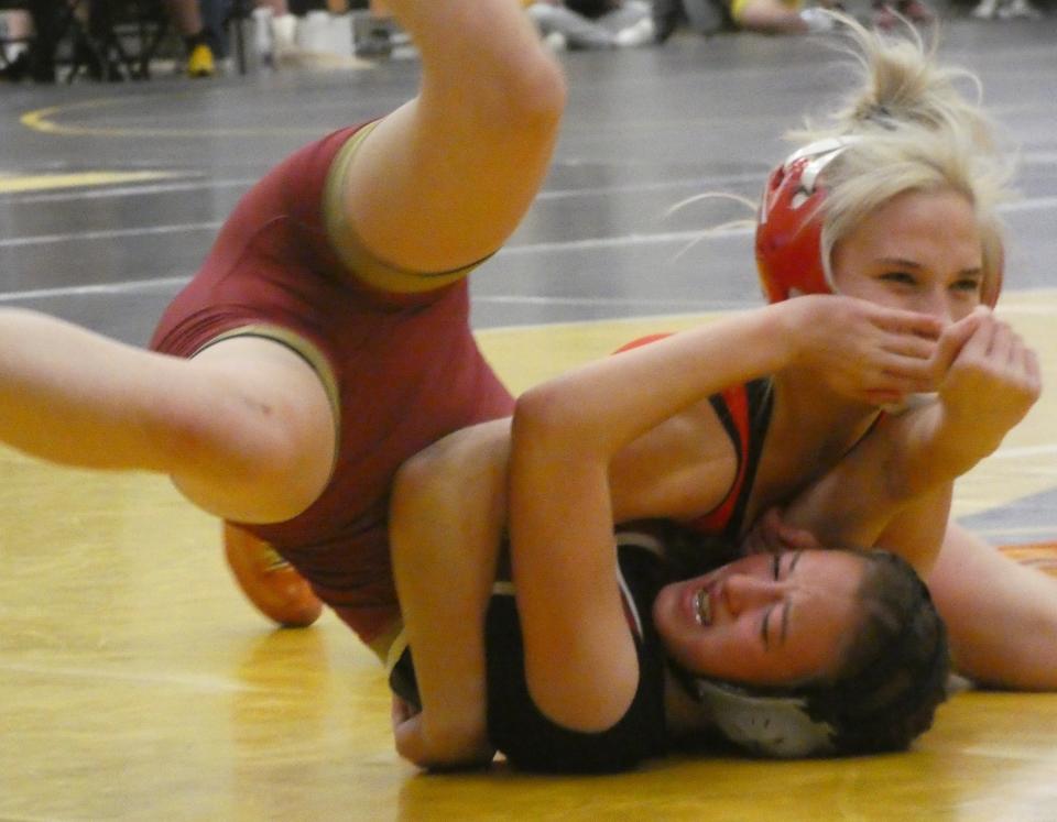 Licking Heights freshman Molly Crabtree, bottom, attempts to escape from Jackson sophomore Makennah Craft, a reigning state champion, in their 100-pound match during the Watkins Girls Wrestling Invitational on Wednesday, Dec. 28, 2022.