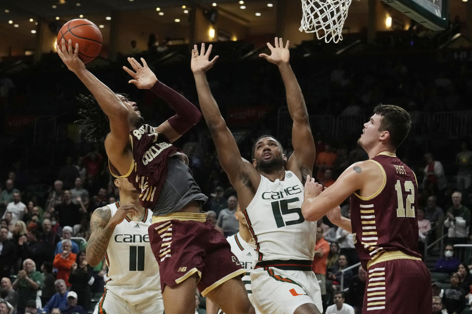 Boston College forward T.J. Bickerstaff (1) aims to score as Miami forward Norchad Omier (15) defends during the second half of an NCAA college basketball game, Wednesday, Jan. 11, 2023, in Coral Gables, Fla. (AP Photo/Marta Lavandier)