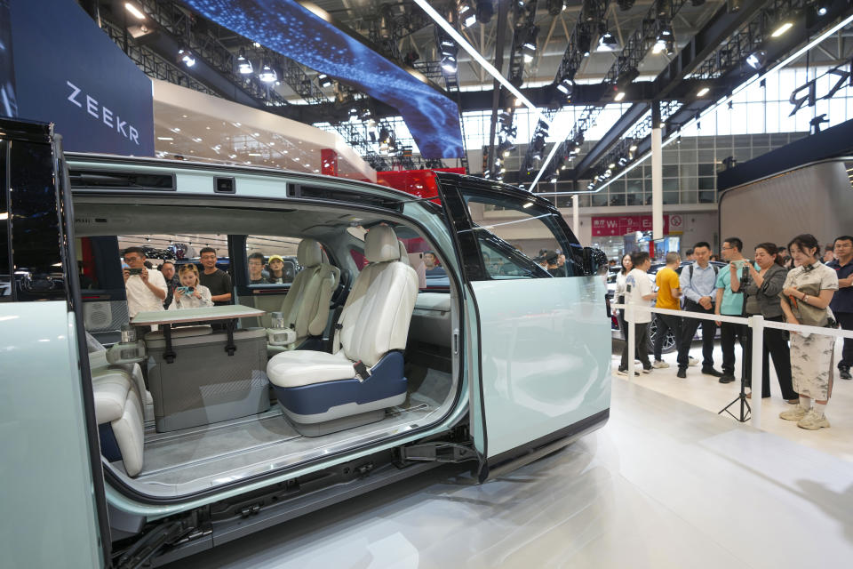 Visitors look at a Zeekr Mix car during the China Auto Show in Beijing, China, Friday, April 26, 2024. China's vision of the future of the automobile electrified and digitally connected is on display at the ongoing Beijing auto show. (AP Photo/Tatan Syuflana)