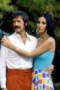 <p>Wearing white hoop earrings, a blue tube top, and printed skirt in a promotional photo for <em>The Sonny and Cher Show</em>.</p>