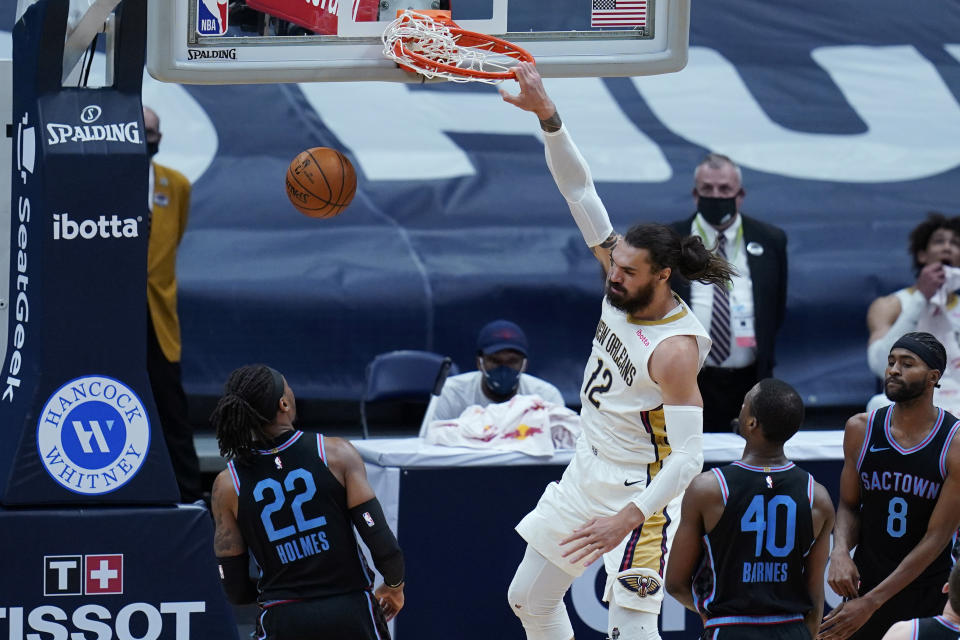 New Orleans Pelicans forward Zion Williamson (1)2 slam dunks over Sacramento Kings center Richaun Holmes (22) in the first half of an NBA basketball game in New Orleans, Monday, April 12, 2021. The Pelicans won 117-110. (AP Photo/Gerald Herbert)