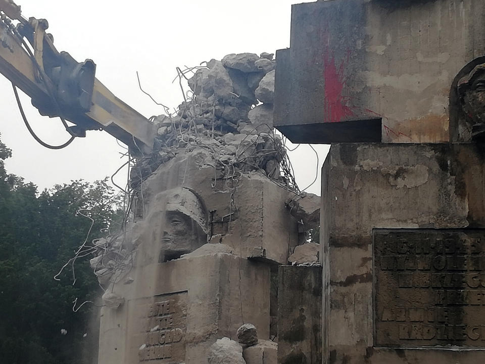 Workers begin to demolish a Soviet-era monument to the Red Army, in Brzeg, Poland, on Wednesday Aug. 24, 2022. Poland on Wednesday began demolishing a memorial to the Soviet Red Army soldiers, an unwanted reminder of the power Moscow once held over Poland whose presence became even more objectionable after Russia's invasion of Ukraine. (IPN Wroclaw via AP)