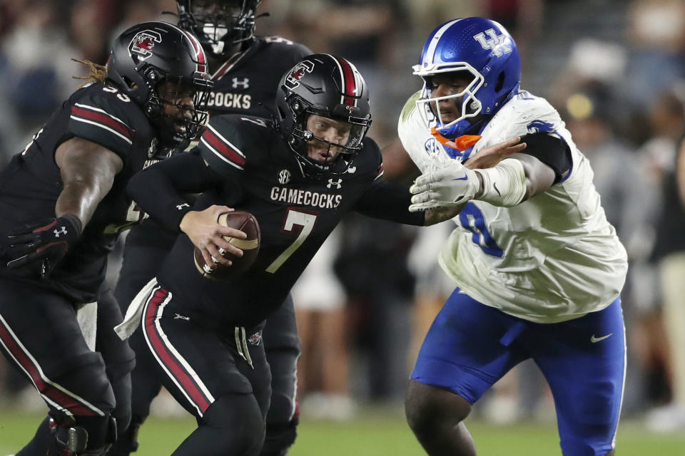South Carolina quarterback Spencer Rattler (7) is tackled by Kentucky defensive lineman Deone Walker (0) during the second half of an NCAA college football game on Saturday, Nov. 18, 2023, in Columbia, S.C. (AP Photo/Artie Walker Jr.)