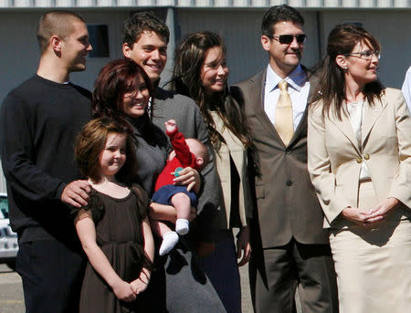 FILE PHOTO: U.S. vice presidential candidate and Alaska Governor Sarah Palin (R) stands with members of her family in Minneapolis, Minnesota September 3, 2008. Palin's family members are (L-R) son Track, daughter Piper, daughter Willow holding infant son Trig, Levi Johnston, boyfriend of daughter Bristol, and Palin's husband Todd. REUTERS/John Gress/File Photo