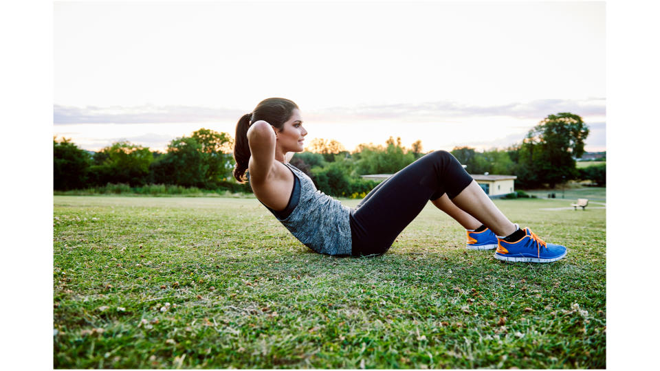 A woman performing a sit-up