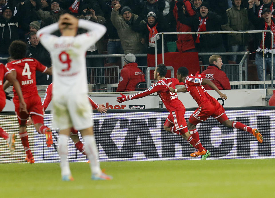 Bayern's Thiago Alcantara of Spain, center, celebrates his side's winning goal during a German first soccer division Bundesliga match between VfB Stuttgart and FC Bayern Munich in Stuttgart, Germany, Wednesday, Jan. 29, 2014. (AP Photo/Michael Probst)