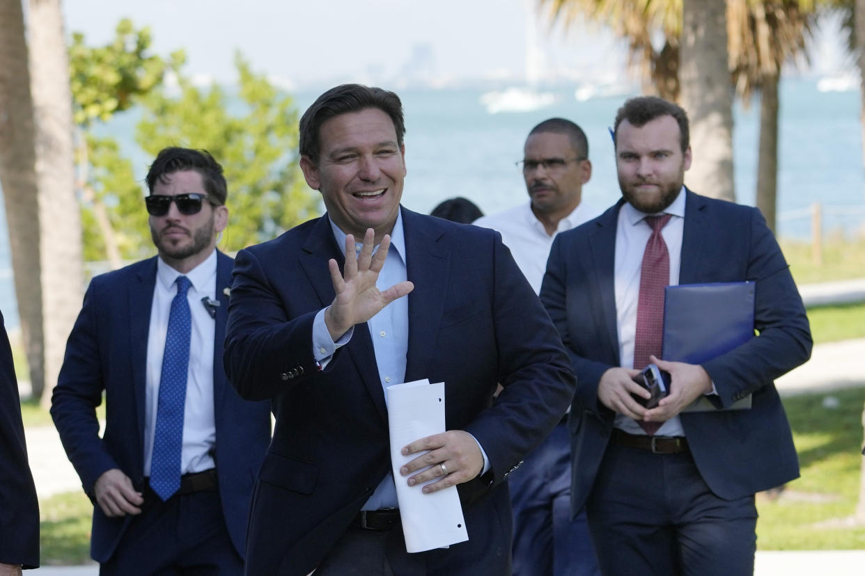 Florida Gov. Ron DeSantis waves as he arrives for a news conference at Bill Baggs Cape Florida State Park, Thursday, Dec. 1, 2022, on Key Biscayne, Fla. (AP Photo/Lynne Sladky)