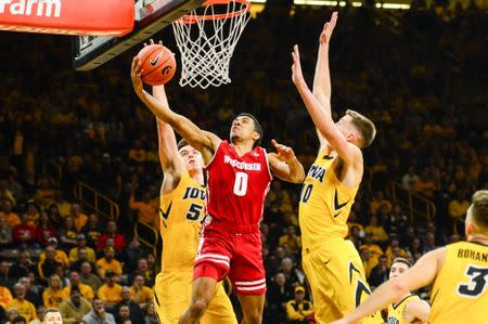 Nov 30, 2018; Iowa City, IA, USA; Wisconsin Badgers guard D'Mitrik Trice (0) goes to the basket as Iowa Hawkeyes forward Nicholas Baer (51) and guard Joe Wieskamp (10) defend during the second half at Carver-Hawkeye Arena. Jeffrey Becker-USA TODAY Sports