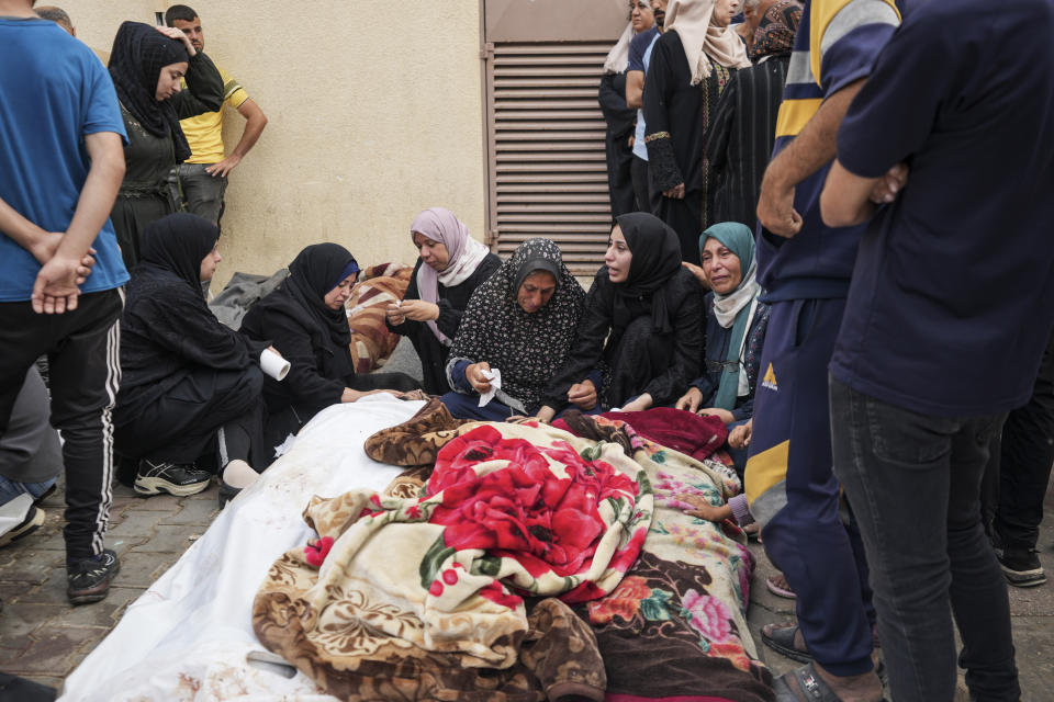 Palestinians mourn relatives killed in an Israeli strike on a U.N.-run school in the Nusseirat refugee camp, outside a hospital in Deir al Balah, Gaza Strip, Thursday, June 6, 2024. The Israeli military said that Hamas militants were operating from within the school. (AP Photo/Abdel Kareem Hana)