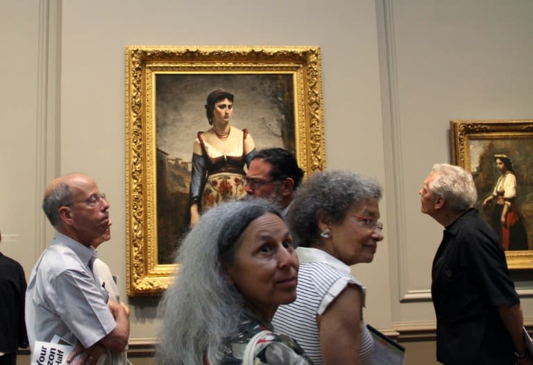 Visitors look at Jean-Baptiste-Camille Corot's "Agostina" (1866) at the National Gallery of Art in Washington on September 5, 2018