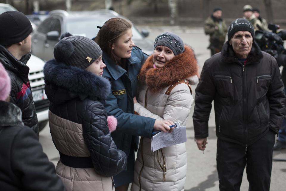 Family members wait outside the Zasyadko coal mine in Donetsk