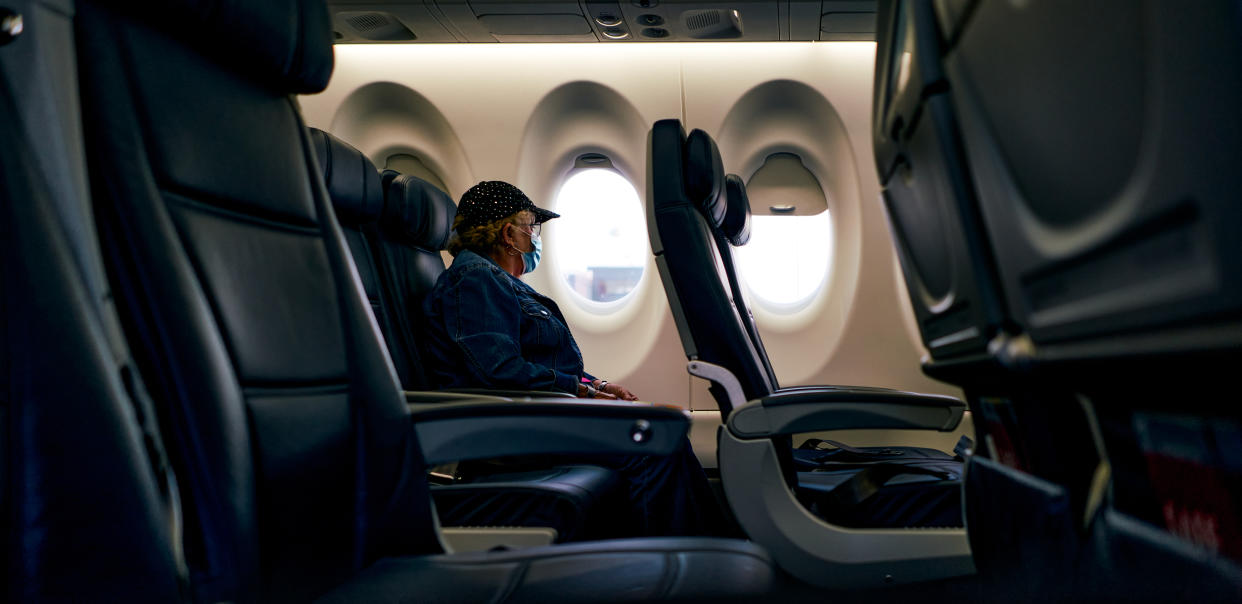 60s woman resting on an empty plane during a flight through the US country