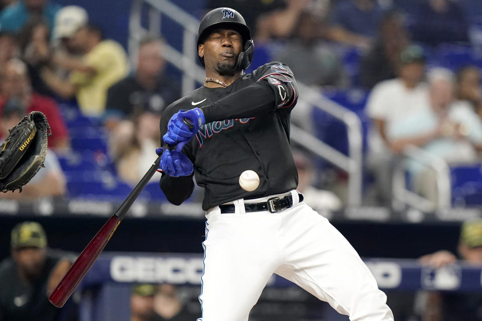 Miami Marlins' Bryan De La Cruz reacts after being hit by a pitch from Atlanta Braves' Charlie Morton during the fourth inning of a baseball game, Friday, May 20, 2022, in Miami. (AP Photo/Lynne Sladky)