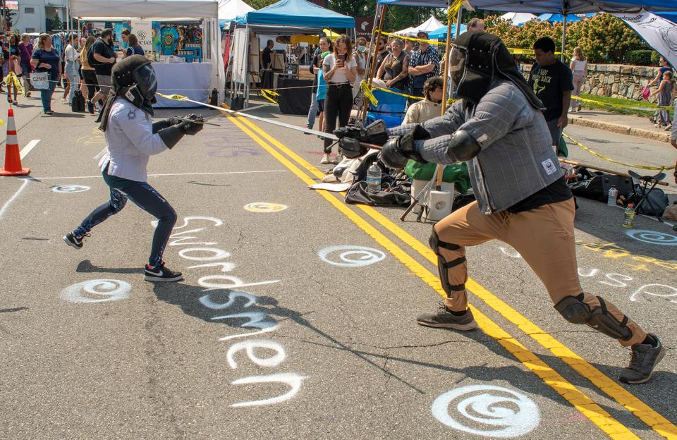 Historical European Martial Arts techniques are demonstrated at the Massachusetts Historical Swordsmanship booth.