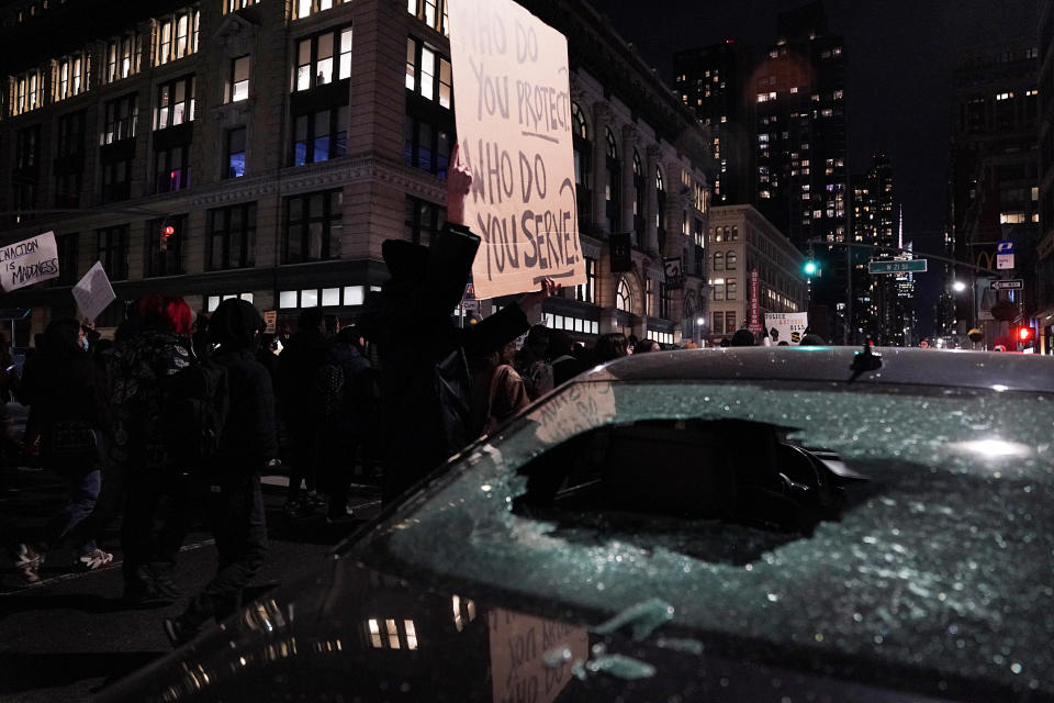 The window of a police cruiser is seen shattered in New York City on Friday.