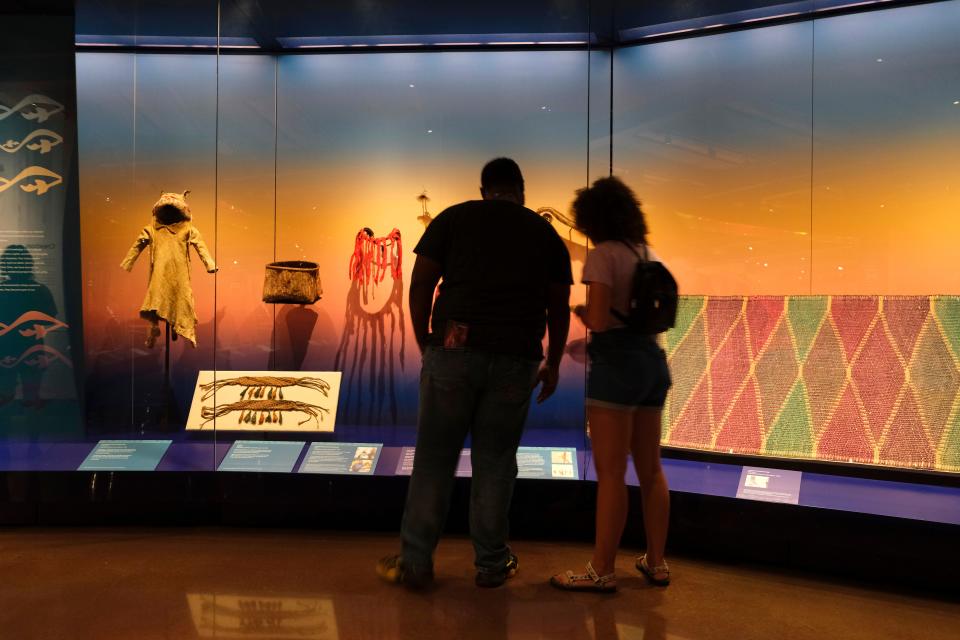 People view WINIKO: Life of an Object, selections from Smithsonian's National Museum of the American Indian, during the opening day of the First Americans Museum (FAM) in 2021.
