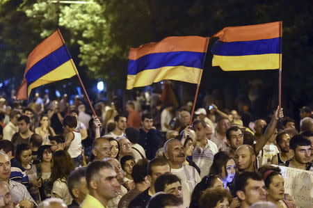 Protesters wave Armenian national flags during a rally against a hike in electricity prices in Yerevan, Armenia July 1, 2015. REUTERS/Hayk Baghdasaryan/Photolure