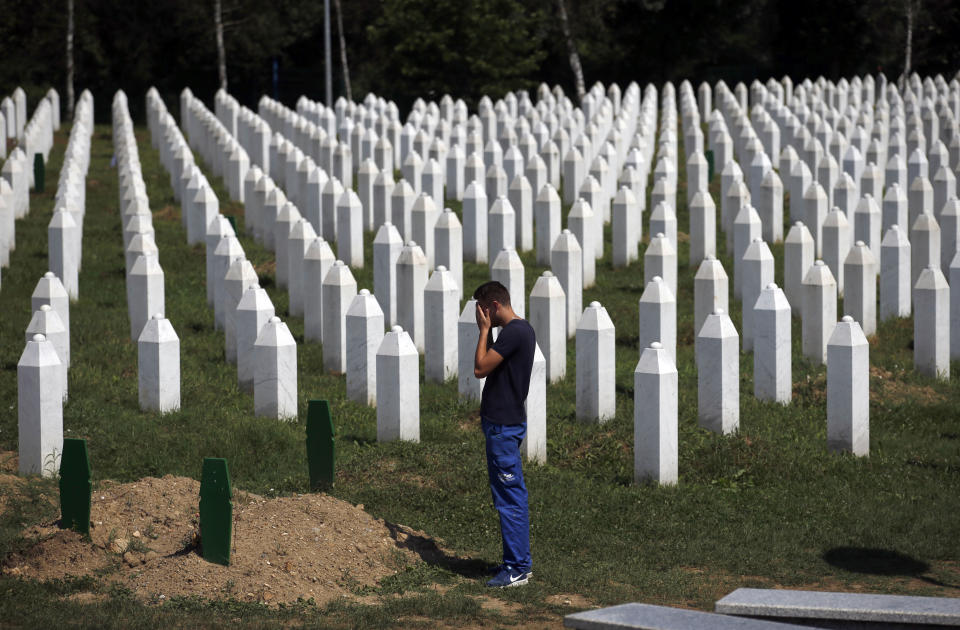 A man prays among gravestones at the memorial centre of Potocari near Srebrenica, 150 kms north east of Sarajevo, Bosnia, Tuesday, Aug. 14, 2018. The leader of Bosnia's Serbs has downplayed the massacre of some 8,000 Bosnian Muslims in Srebrenica during the war in 1995 and called for the reopening of an investigation into the worst carnage in Europe since World War II. (AP Photo/Darko Vojinovic)