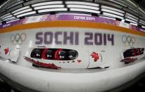 Canada's pilot Chris Spring (front) and his teammates speed down the track during a four-man bobsleigh training session at the Sanki Sliding Center in Rosa Khutor, during the Sochi 2014 Winter Olympics February 19, 2014. Picture taken with multiple exposure. REUTERS/Fabrizio Bensch (RUSSIA - Tags: SPORT BOBSLEIGH OLYMPICS)