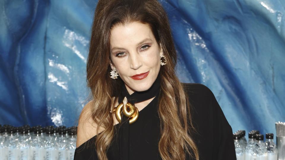 lisa marie presley standing for a photo at the golden globe awards
