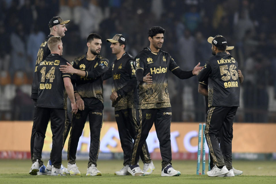 Peshawar Zalmi' Naveen-ul-Haq, third left, celebrates with teammates after winning the Pakistan Super League T20 cricket match between against Multan Sultans, in Multan, Pakistan Friday, Feb. 23, 2024. (AP Photo/M. Khan)