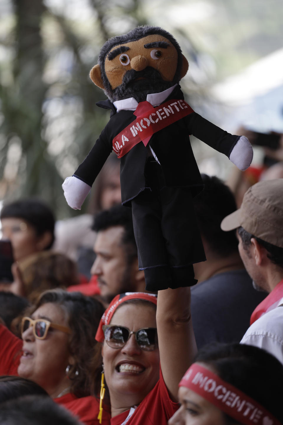 A woman holds up a doll depicting Brazil's former President Luiz Inacio Lula da Silva during a rally at the Metal Workers Union headquarters, in Sao Bernardo, Brazil, Saturday, Nov. 9, 2019. Da Silva was released from jail Friday, less than a day after the Supreme Court ruled that a person can be imprisoned only after all the appeals have been exhausted. (AP Photo/Nelson Antoine)