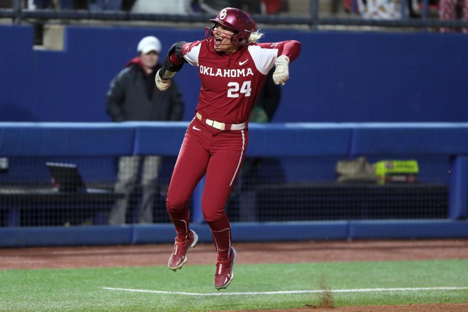 Oklahoma's Jayda Coleman (24) celebrates after hitting a home run in the first inning of a college softball game between the University of Oklahoma Sooners (OU) and the Auburn Tigers at USA Softball Hall of Fame Stadium in Oklahoma City, Saturday, March 18, 2023. 