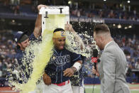 Tampa Bay Rays' Yandy Diaz is dunked with sports drink by teammates Josh Lowe, left and Brandon Lowe after hitting a walk off two-run home run against the Seattle Mariners during a baseball game Saturday, Sept. 9, 2023, in St. Petersburg, Fla. (AP Photo/Scott Audette)