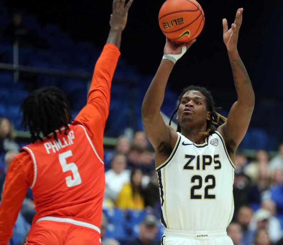 Akron Zips guard Mikal Dawson (22) shoots a 3-pointer over Bowling Green guard Da'Shawn Phillip (5) during the first half, Friday, Jan. 5, 2024.