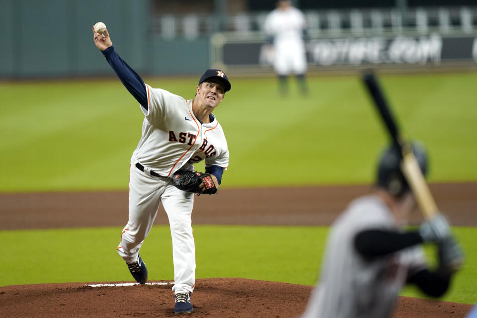 Houston Astros starting pitcher Zack Greinke, left, throws to Arizona Diamondbacks' Christian Walker during the first inning of a baseball game Friday, Sept. 18, 2020, in Houston. (AP Photo/David J. Phillip)