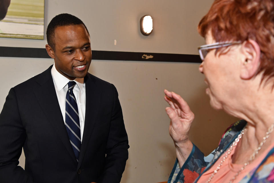 Kentucky Attorney General and Kentucky gubernatorial candidate Daniel Cameron speaks with a supporter during a campaign stop in Richmond, Ky., Wednesday, May 3, 2023. (AP Photo/Timothy D. Easley)