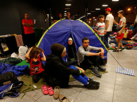 FILE PHOTO: Asylum seekers wait outside a train station in Budapest, Hungary, August 28, 2015. REUTERS/Laszlo Balogh/File Photo