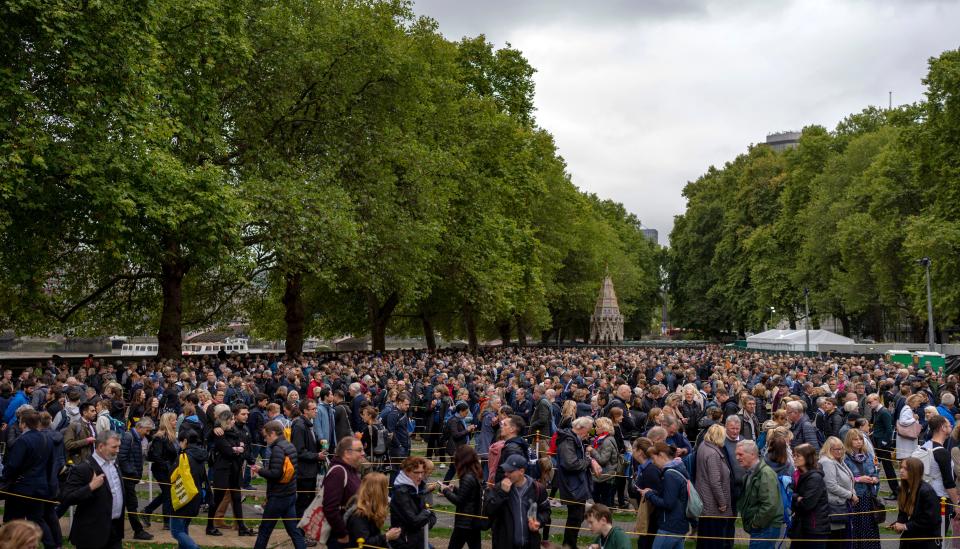 Crowds weave around on their way to Westminster (AP)