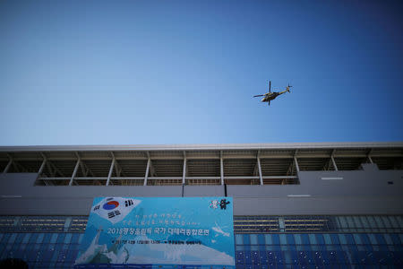 A South Korean army helicopter flies over the Olympic Stadium, the venue for the opening and closing ceremony during a security drill ahead of the 2018 Pyeongchang Winter Olympic Games in Pyeongchang, South Korea December 12, 2017. REUTERS/Kim Hong-Ji/Files