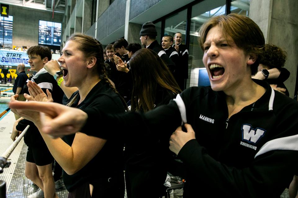 Waukee's Levi Manning, right, celebrates with teammates during the high school boys state swimming championship.