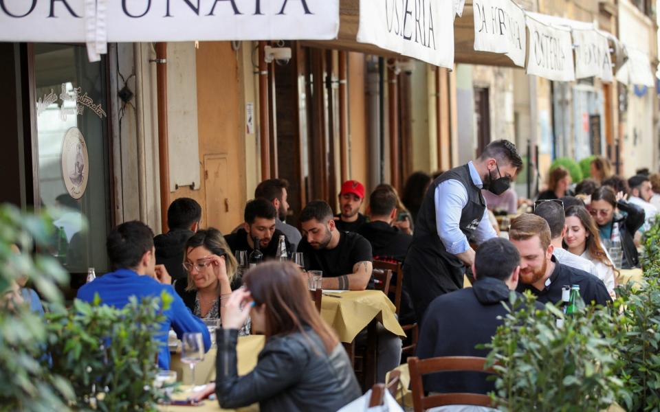 People sit down for lunch at a restaurant in Rome, Italy, as much of the country becomes a 'yellow zone' - YARA NARDI/REUTERS