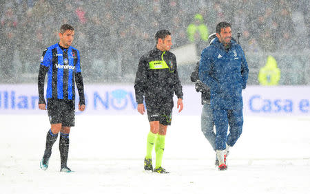 Soccer Football - Serie A - Juventus v Atalanta - Allianz Stadium, Turin, Italy - February 25, 2018 Juventus’ Gianluigi Buffon with Atalanta's Rafael Toloi and the referee in the snow as the match was postponed REUTERS/Massimo Pinca