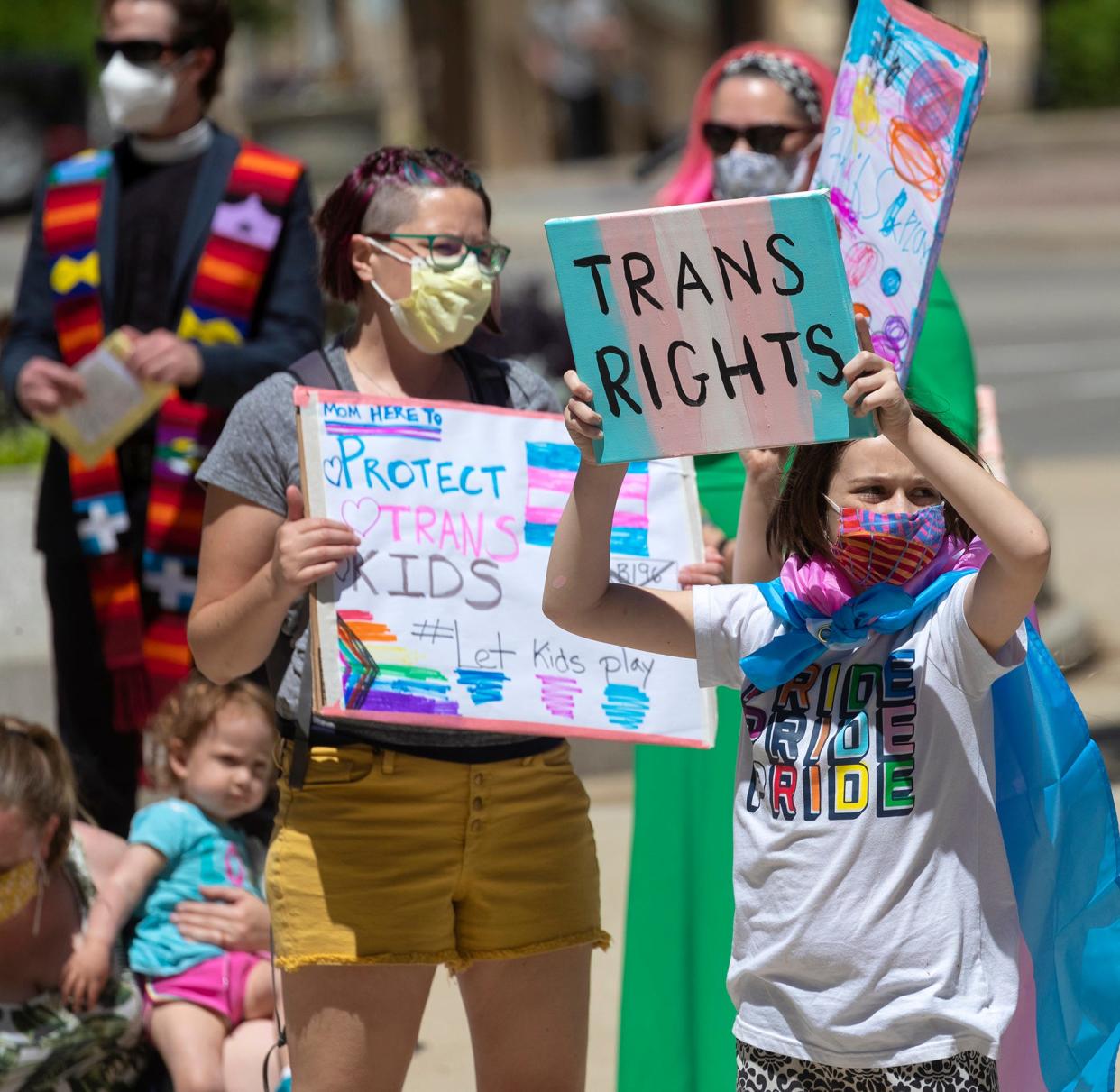 Julian Niebauer, a 10-year-old transgender boy, takes part in a  rally for transgender rights that drew about 75 people Wednesday, May 26, 2021 at the Capitol in Madison, Wis. He is from Middleton, Wis. Republicans who control the state Legislature are holding hearings Wednesday on legislation that would ban transgender athletes from competing in girls' and women's school sports — a proposal opposed by nearly 20 groups, including the statewide body that oversees high school sports.