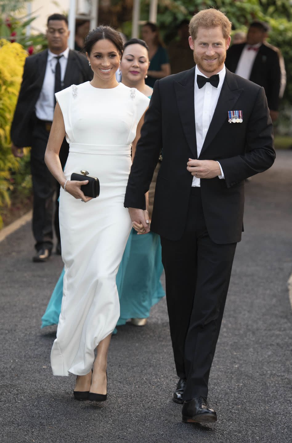 <p>Meghan was showing off a shoulder moment long before the era of Zoom meetings, as she did in this long white maxi dress for a state dinner in Tonga during the royal tour of Australia, Fiji, Tonga, and New Zealand in 2018. </p>