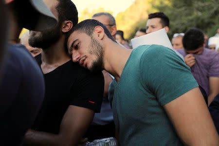 A man mourns during the funeral of Druze police officer Kamil Shanan in the village of Hurfeish, Israel July 14 2017. REUTERS/Ammar Awad