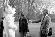 <p>President Jimmy Carter greets the Easter Bunny prior to his departure for a weekend at Camp David in Washington March 22, 1978. Inside the rabbit suit is Louise Dolan, who wore the suit to the departure as a gag. First lady Rosalynn Carter is speaking to Suzy Kerr who works with Dolan in the White House. (Photo: Jeff Taylor/AP) </p>