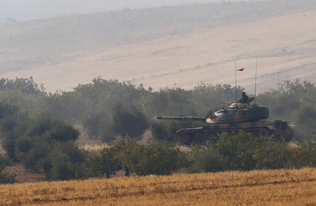 A Turkish army tank drives towards to the border in Karkamis on the Turkish-Syrian border in the southeastern Gaziantep province, Turkey, August 25, 2016. REUTERS/Umit Bektas