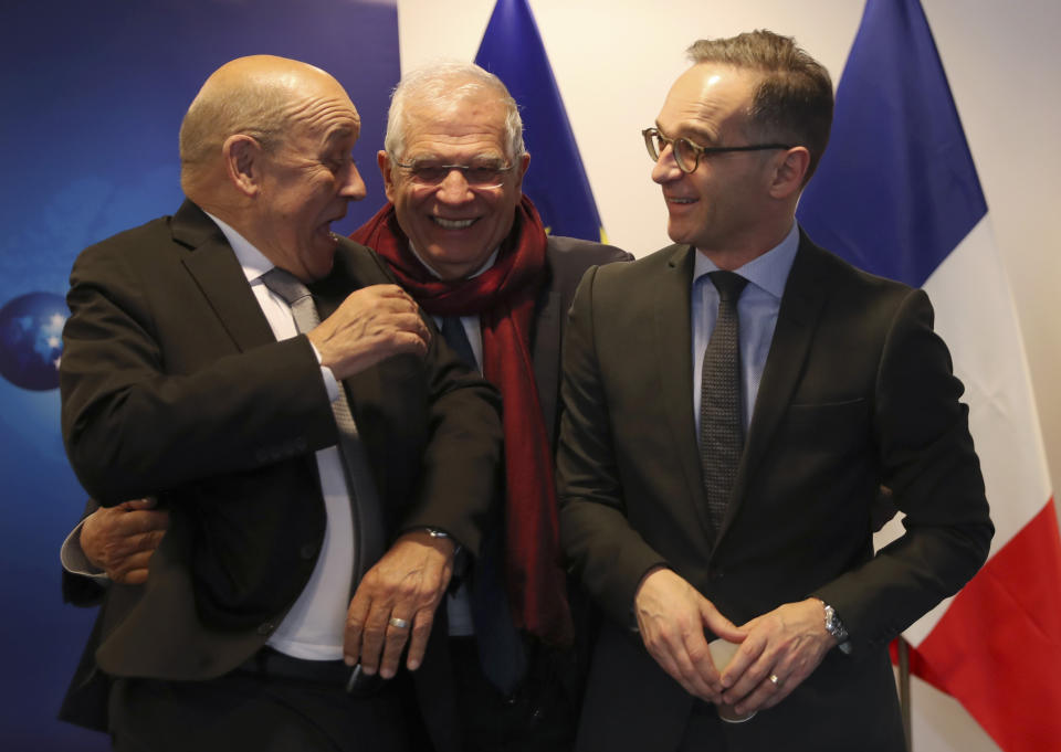 European Union foreign policy chief Josep Borrell, center, speaks with German Foreign Minister Heiko Maas, right, and French Foreign Minister Jean-Yves Le Drian, left, as they pose for a photo prior to a meeting to discuss the situation in Libya at the EEAS building in Brussels, Tuesday, Jan. 7, 2020. The ministers will also hold talks later Tuesday which are expected to center on the situation in Iran and Iraq. (AP Photo/Francisco Seco, Pool)