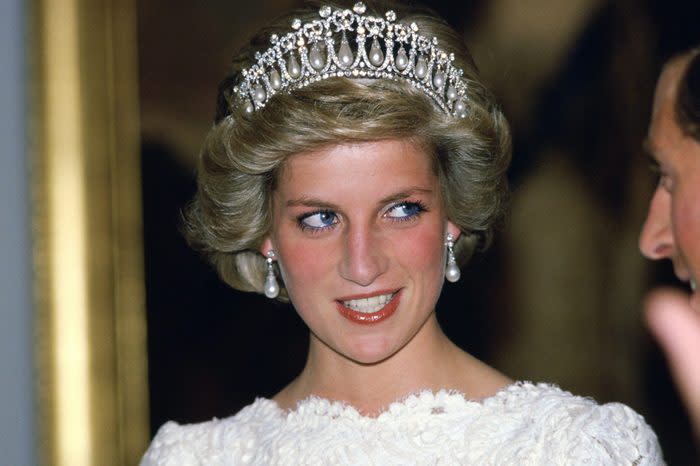 WASHINGTON, UNITED STATES - NOVEMBER 11: Diana, Princess Of Wales, Talking To Her Husband, During A Visit To The British Embassy. The Princess Is Wearing A Taffeta And Lace Gown With A Scalloped Neckline Designed By Murray Arbeid With Queen Mary's Diamond And Pearl Tiara, A Present From The Queen. (Photo by Tim Graham Photo Library via Getty Images)