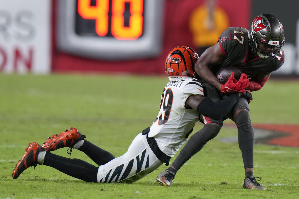 Cincinnati Bengals cornerback Cam Taylor-Britt (29) stops Tampa Bay Buccaneers wide receiver Russell Gage (17) during the second half of an NFL football game, Sunday, Dec. 18, 2022, in Tampa, Fla. (AP Photo/Chris O'Meara)