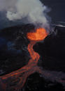 FILE - Lava flows downhill from the crater of Mauna Loa, April 5, 1984, on the island of Hawaii. The ground is shaking and swelling at Mauna Loa, the largest active volcano in the world, indicating that it could erupt. Scientists say they don't expect that to happen right away but officials on the Big Island of Hawaii are telling residents to be prepared in case it does erupt soon. (AP Photo/John Swart, File)