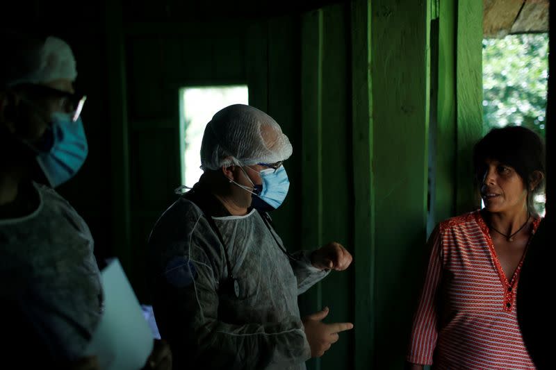 Members of the Brazilian Armed Forces medical team examines a woman from the indigenous Yanomami ethnic group, amid the spread of the coronavirus disease (COVID-19), at the Waikas region in the municipality of Auaris